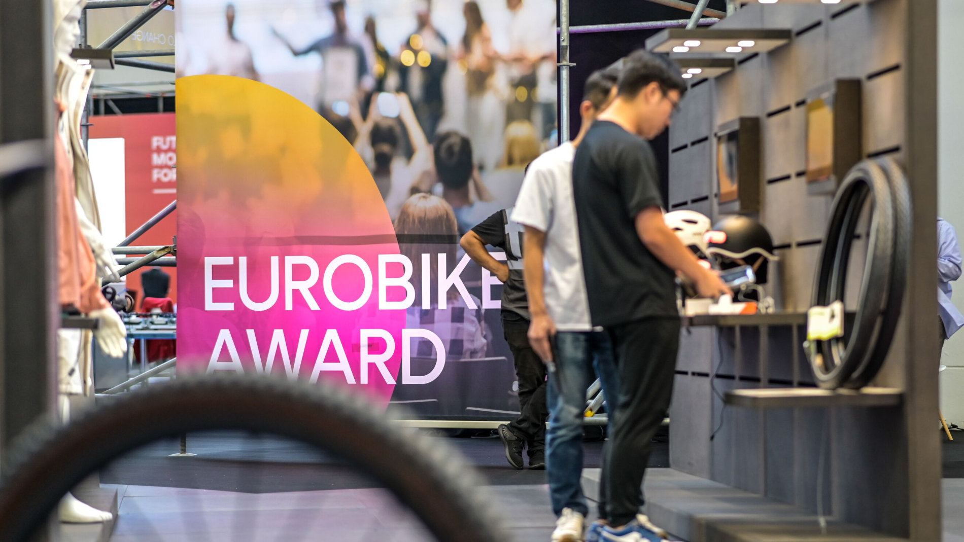 Visitors at the EUROBIKE Award stand with bicycles on display