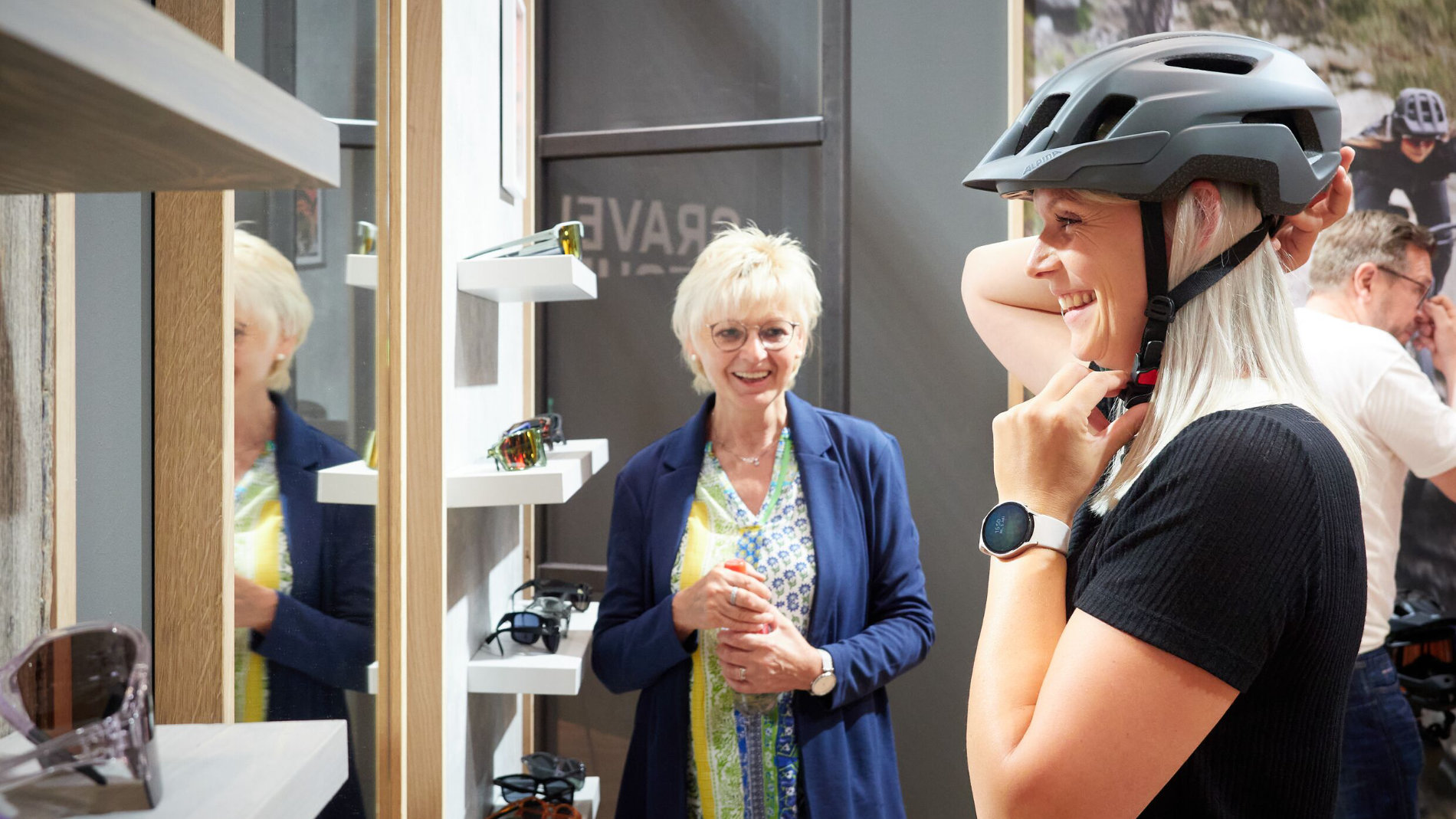 Visitor tries on a bicycle helmet at the exhibition stand