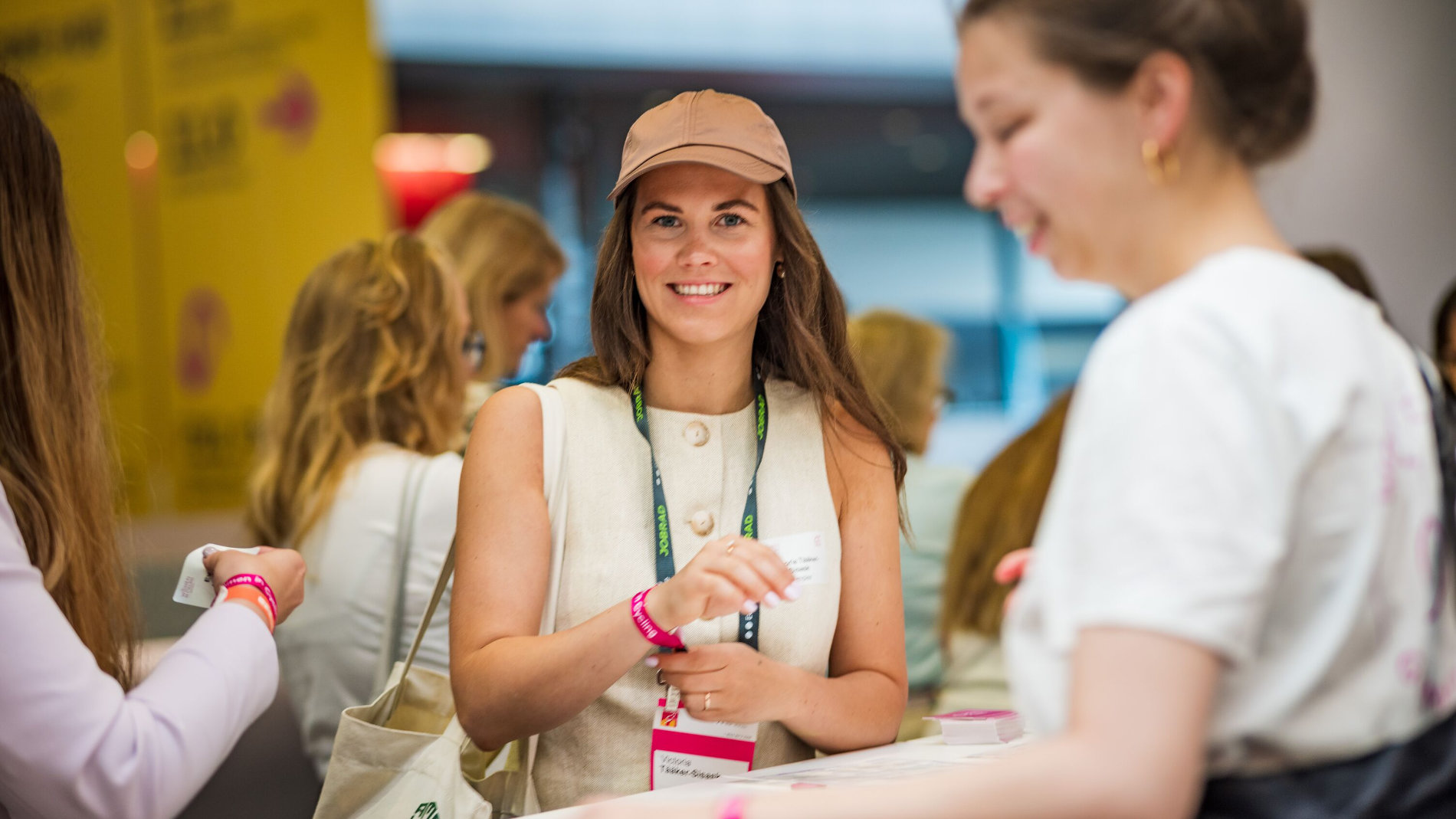 Visitor wearing an event lanyard at the trade fair booth