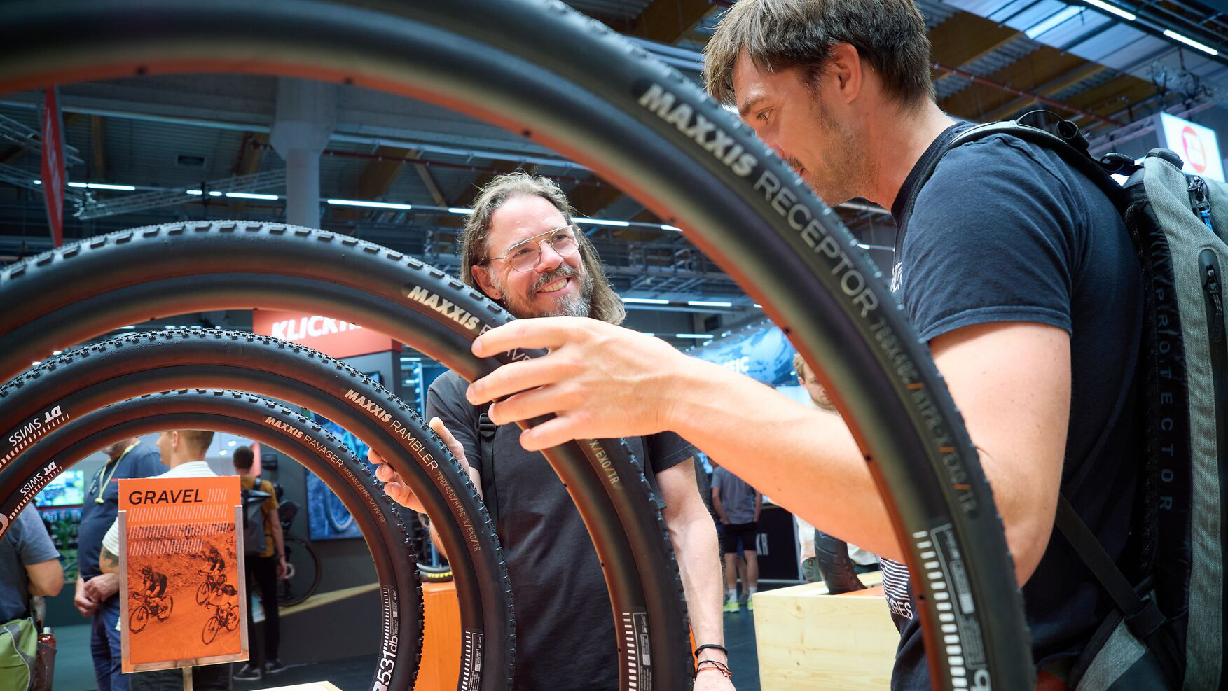 Two visitors examining bicycle tires