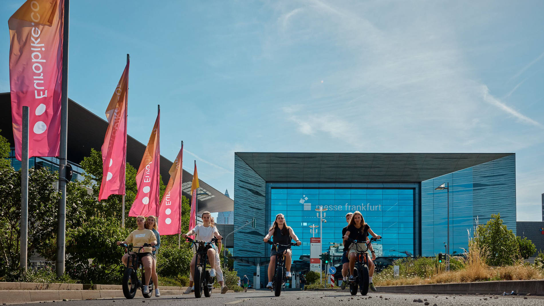 Cyclists in front of Messe Frankfurt entrance