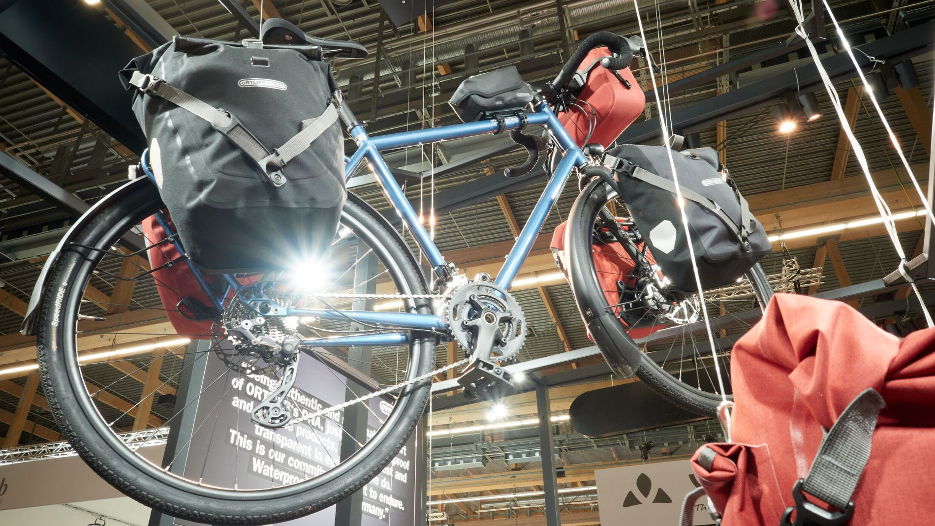 Touring bicycle with panniers displayed at trade fair